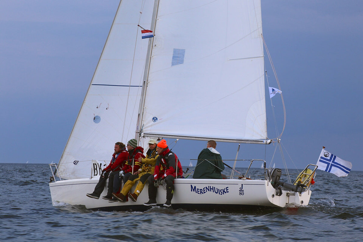 J/80 with its crew hiking on the rail